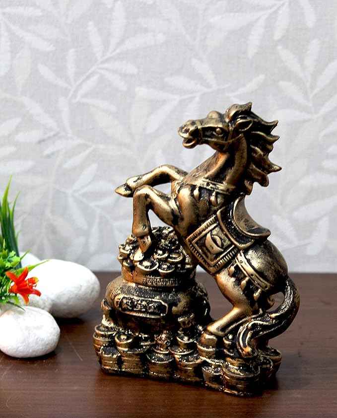 Feng Shui Golden Horse statue for wealth, success, and prosperity, elegant home decor on a wooden surface.