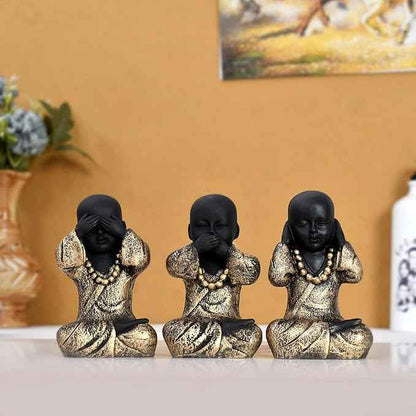 Set of 3 black and gold monk statues with 'See No Evil, Hear No Evil, Speak No Evil' poses for Zen decor.