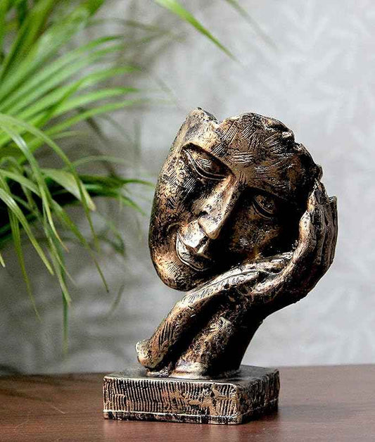 Bit Nite artistic tabletop face sculpture with a bronze finish, showing a contemplative face resting on a hand.