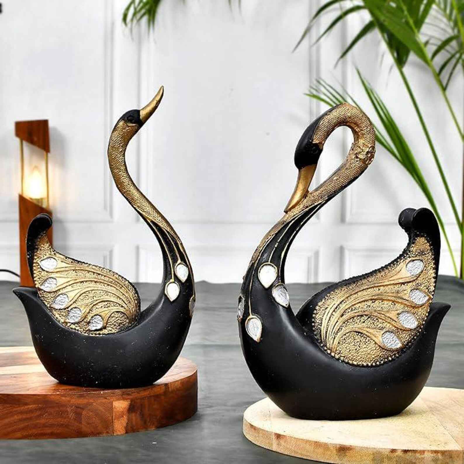 SwaSha black & gold resin swan sculptures, luxury home decor pair on wooden platforms. Modern animal figurines.