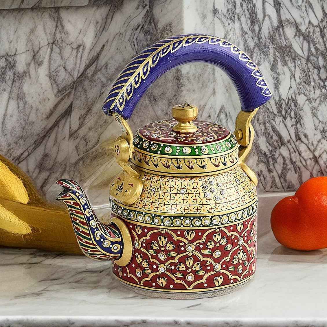 SwaSha Handcrafted Rajasthani decorative tea kettle, colorful floral patterns, blue handle, on marble surface.
